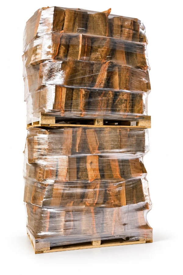 Net sacks of kiln dried logs stacked and wrapped on a pallet